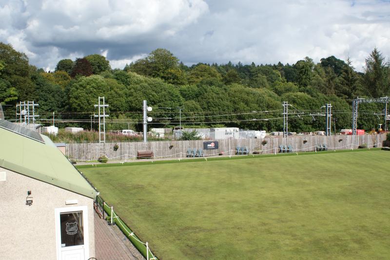Photo of The new sections of copper wire glint in the sun beside Dunblane Bowling Club